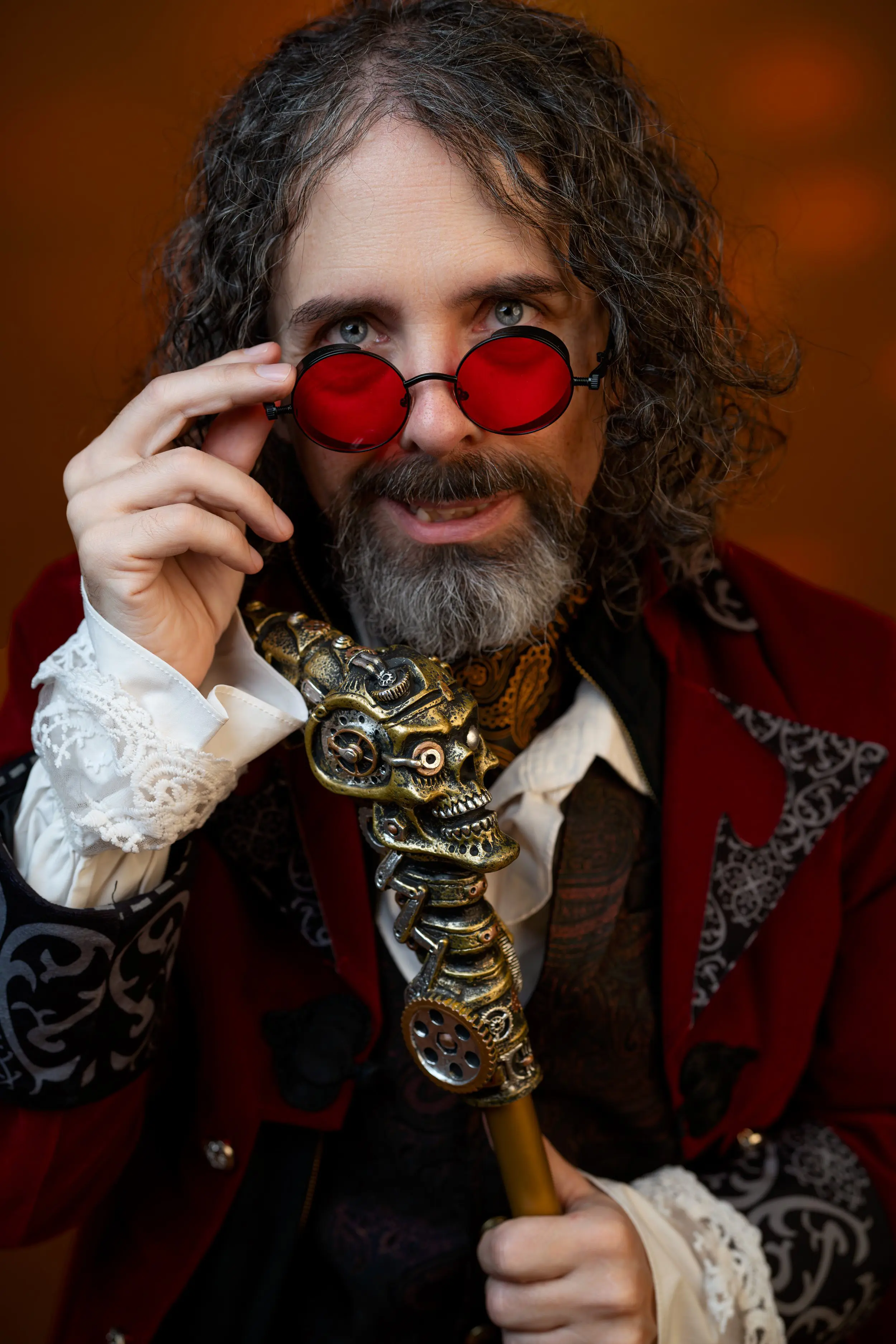 Richard Mathis — the cook behind Late Night Cravings — in red-tinted round glasses, peering over the rims.